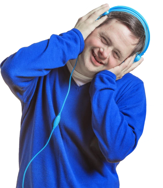 A child with Down syndrome in a blue sweater holds a headset